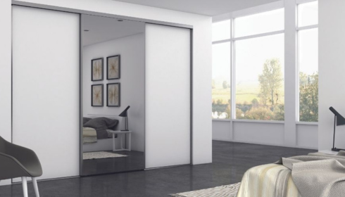  In what way can swapping heavy doors for sliding ones free up space in small rooms